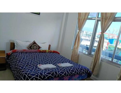 a bedroom with a bed with two pillows on it at Hotel Snowland, Tawang in Tawang