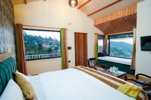 a bedroom with a bed and a large window at Monal Meadows in Bhīm Tāl