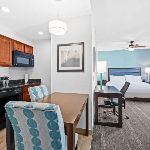 a living room with a dining room table and a bed at Homewood Suites by Hilton Fort Lauderdale Airport-Cruise Port in Dania Beach
