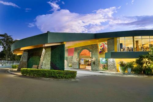 a rendering of a building with a green at Hilton Cariari DoubleTree San Jose - Costa Rica in San José