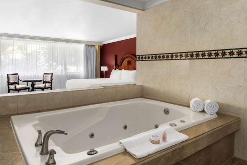 a bathroom with a large bath tub in a hotel room at Hilton Cariari DoubleTree San Jose - Costa Rica in San José