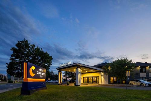 a gas station with a sign in front of it at Comfort Inn Montreal Aeroport in Pointe-Claire