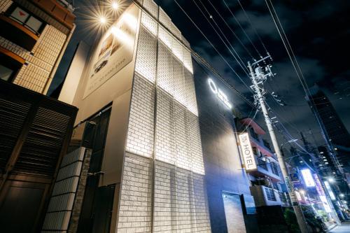 a building with lights on the side of it at night at Hotel The Loop in Tokyo