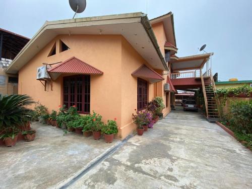 a building with potted plants in front of it at Casa Raihan in Virajpet