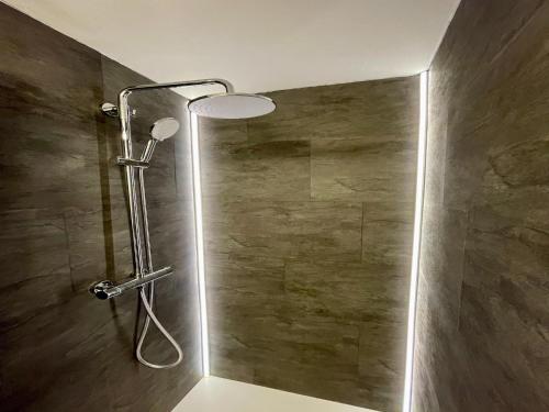 a shower with a shower head in a bathroom at Chalet in Mayrhofen near Ski Slopes in Mayrhofen