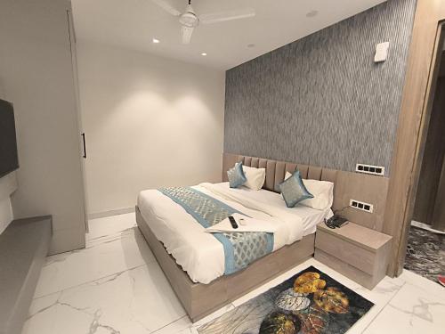 a bedroom with a large bed in a room at Prime Hotel - 2 Mins From Durgabai Deshmukh South Campus Metro in New Delhi