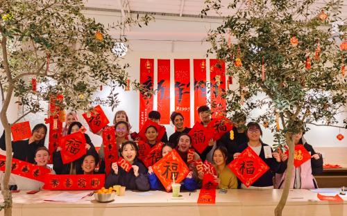a group of people posing for a picture with red signs at Hi Cozy International Youth Hostel East Nanjing Road & The Bund - Free Gym in Shanghai
