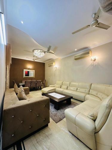 a large living room with couches and a table at Luxury HomeStay Prime Location, South Delhi in New Delhi