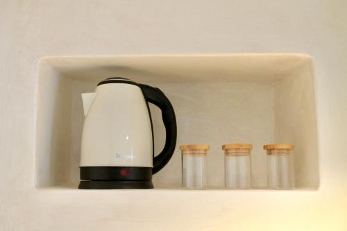 a black and white coffee maker sitting on a shelf at CASSIODORO - Home & Terrace in Ostuni