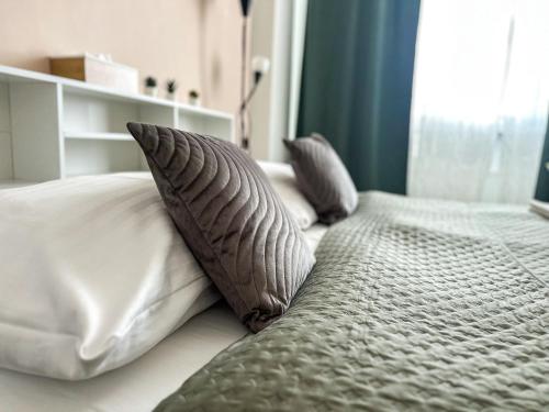 a bed with two pillows on top of it at Kampus Palace in Ostrava