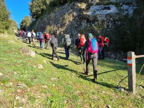 a group of people walking down a mountain path at LIMO to Host in Roccaromana