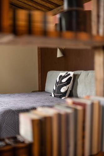 a bed with a black and white pillow on it at Desa Seni Baturiti in Baturiti