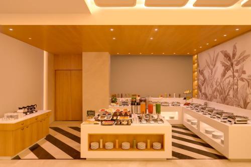 a large room with a buffet of food on display at Keys Prima by Lemon Tree Hotels, Kota, Rajasthan in Kota