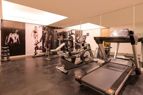 a gym with several treadmills and exercise bikes at Keys Prima by Lemon Tree Hotels, Kota, Rajasthan in Kota