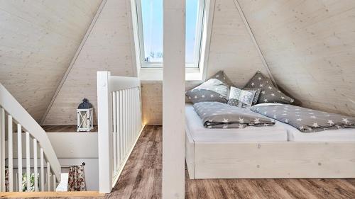 a white bed with pillows on it in a attic at Hohwarthof in Breitnau