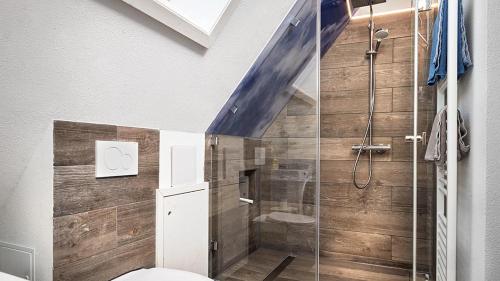 a bathroom with a toilet and a glass shower at Hohwarthof in Breitnau