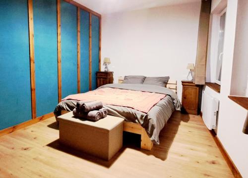 a bedroom with a bed and a table in it at Schlupfgass' - Centre historique in Wissembourg