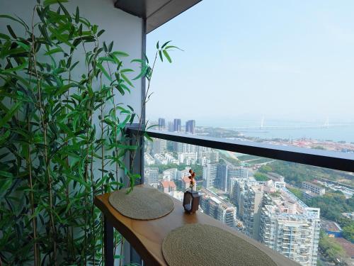 a room with a window with a view of a city at Interact China Fine Condo - Shenzhen Bay in Shenzhen