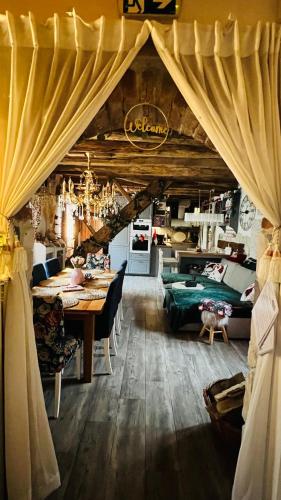 a dining room with a table and a bed at Kuća za odmor Čarolija in Jastrebarsko