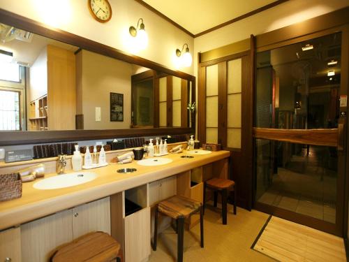 a bathroom with two sinks and a large mirror at Dormy Inn Premium Wakayama Natural Hot Spring in Wakayama