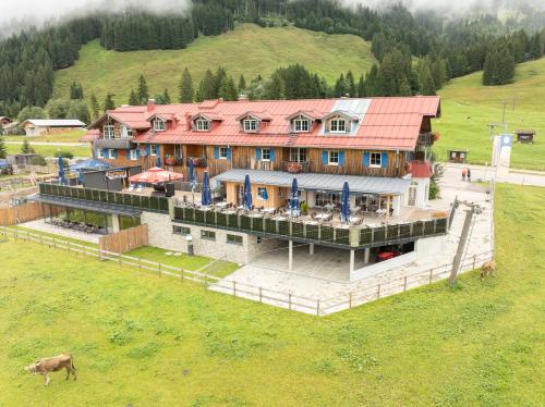 an aerial view of a house in a field at Gasthof Schwabenhof in Balderschwang