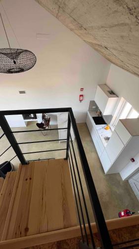 a view of a room with a staircase in a house at Vale das Estrelas in São Teotónio