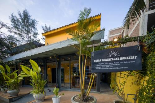 un edificio con un cartel delante en Hoian Beachfront Homestay, en Tân Thành (1)