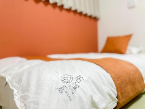 a pillow with a skull and crossbones on a bed at HANASTAY花渓居 · 海（UMI) in Osaka