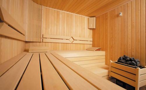 an empty sauna with wooden walls and wooden floors at Atlantis Residences Melaka in Melaka