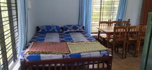 una camera con un letto e un tavolo e una sala da pranzo di StayCool Homestay near Airport a Mangalore