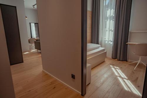 a room with a door to a room with a bedroom at Mariandl am Berg in Amberg