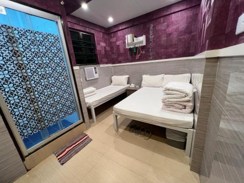 a room with a bench and a shower with purple walls at 168 Youth Hostel in Hong Kong