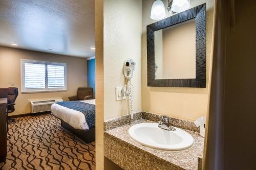 a hotel room with a sink and a bed at Americas Best Value Inn Richmond in Richmond