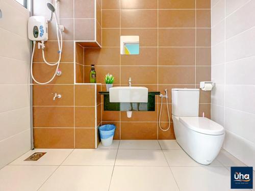 a bathroom with a toilet and a sink at Bandar Dato Onn By UHA in Johor Bahru