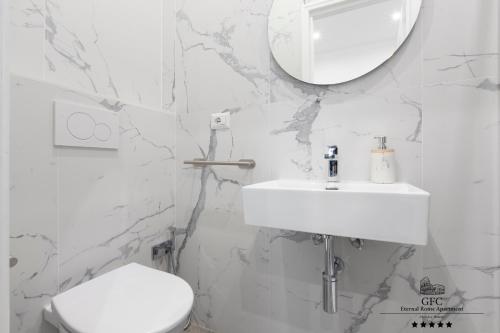a white bathroom with a sink and a toilet at GFC Eternal Rome Apartment - 5min to Tiburtina Station MetroB, 2 Bathrooms, Terrace, A-C in Rome