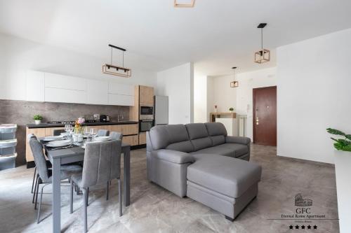 a kitchen and dining room with a table and a couch at GFC Eternal Rome Apartment - 5min to Tiburtina Station MetroB, 2 Bathrooms, Terrace, A-C in Rome