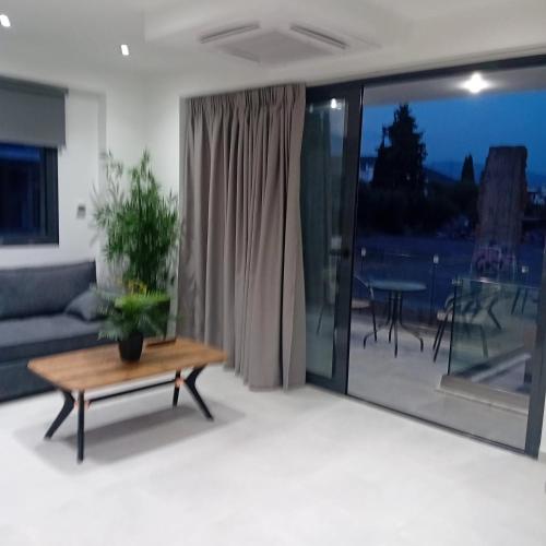 a living room with a couch and a table at arvangroup-apartments in Nafpaktos