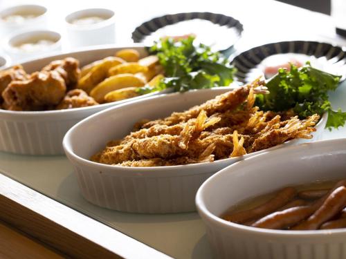 a buffet with three dishes of food on a table at Dormy Inn Premium Wakayama Natural Hot Spring in Wakayama