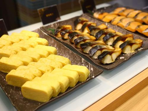 three trays of food on a buffet table at Dormy Inn Premium Wakayama Natural Hot Spring in Wakayama