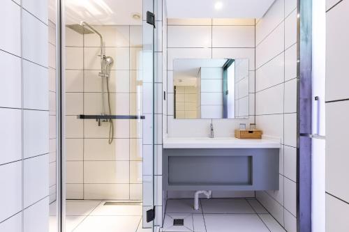 a bathroom with a sink and a shower at LZ Hotel in Chengdu