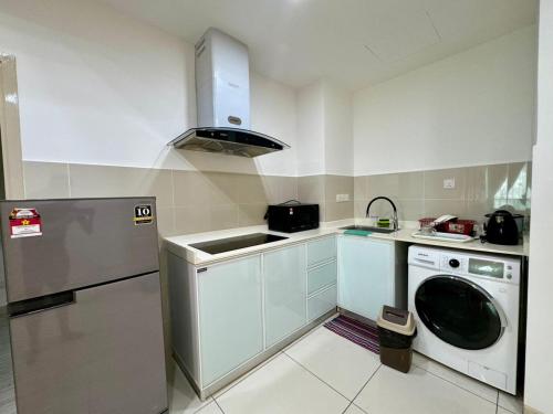 a kitchen with a washing machine and a sink at SA Sutera Avenue Homestay Opposite Imago KK in Kota Kinabalu