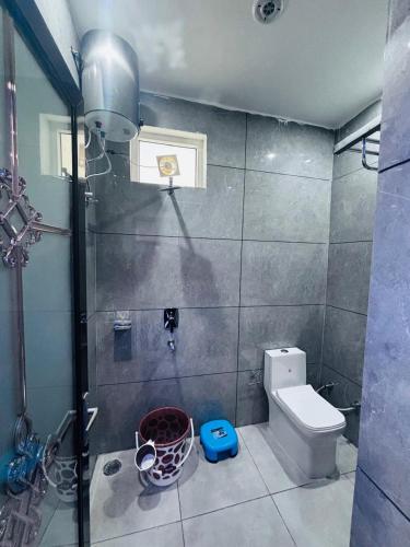 a bathroom with a shower and a toilet in it at Hotel Amrit Bliss in Rishīkesh