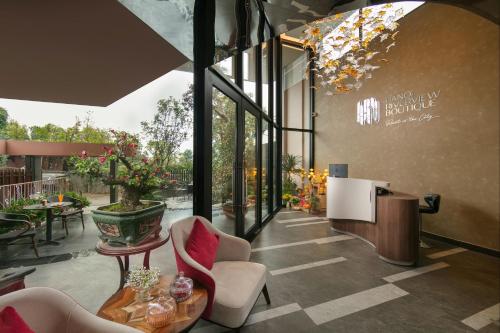 a lobby with chairs and tables in a building at Hanoi Riverview Boutique Hotel & Apartment in Hanoi