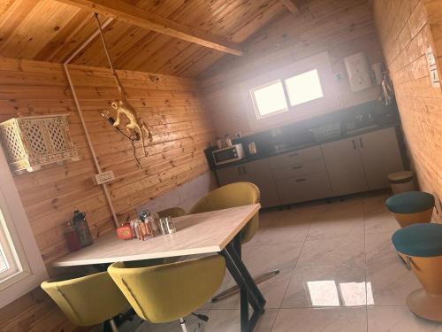 a dining room with a table and chairs at Private pool with 3 bhk farm house Kuku farm stay # Moinabad in Venkatāpur