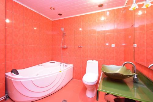 a bathroom with a tub and a toilet and a sink at Rooms in the heart of Yerevan 4 in Yerevan