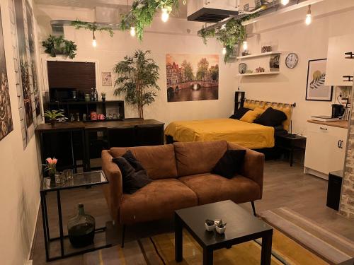 a living room with a couch and a bed at The Studio no windows 20 minutes by bus to downtown Amsterdam in Purmerend