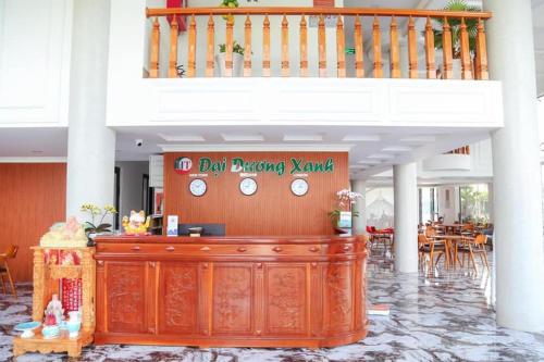 a restaurant with a desk with clocks on it at Blue Ocean Hotel Phan Thiết - by BAY LUXURY in Ấp Bình Hưng