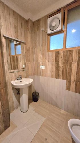 a bathroom with a sink and a window at Hotel Akashdeep in McLeod Ganj