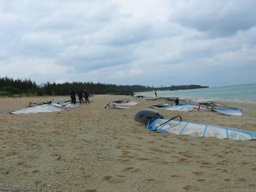a group of people on a beach with kites at Minshuku Myojoso in Yoron