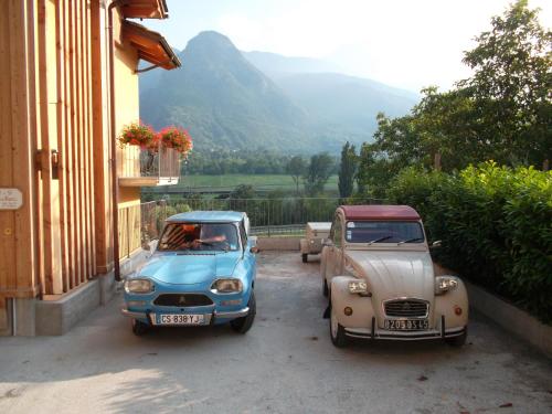 two old cars parked next to a building at Affittacamere Les Noyers in Verrayes